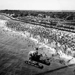 "NYC Police helicopter hovering over Independence Day crowd at beach at Far Rockaway, Queens, NY. "July 04, 1953